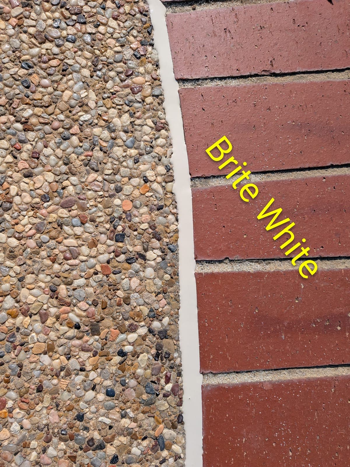 Sika Brite White pool mastic sealant color example between exposed aggregate concrete and red brick — smooth finish