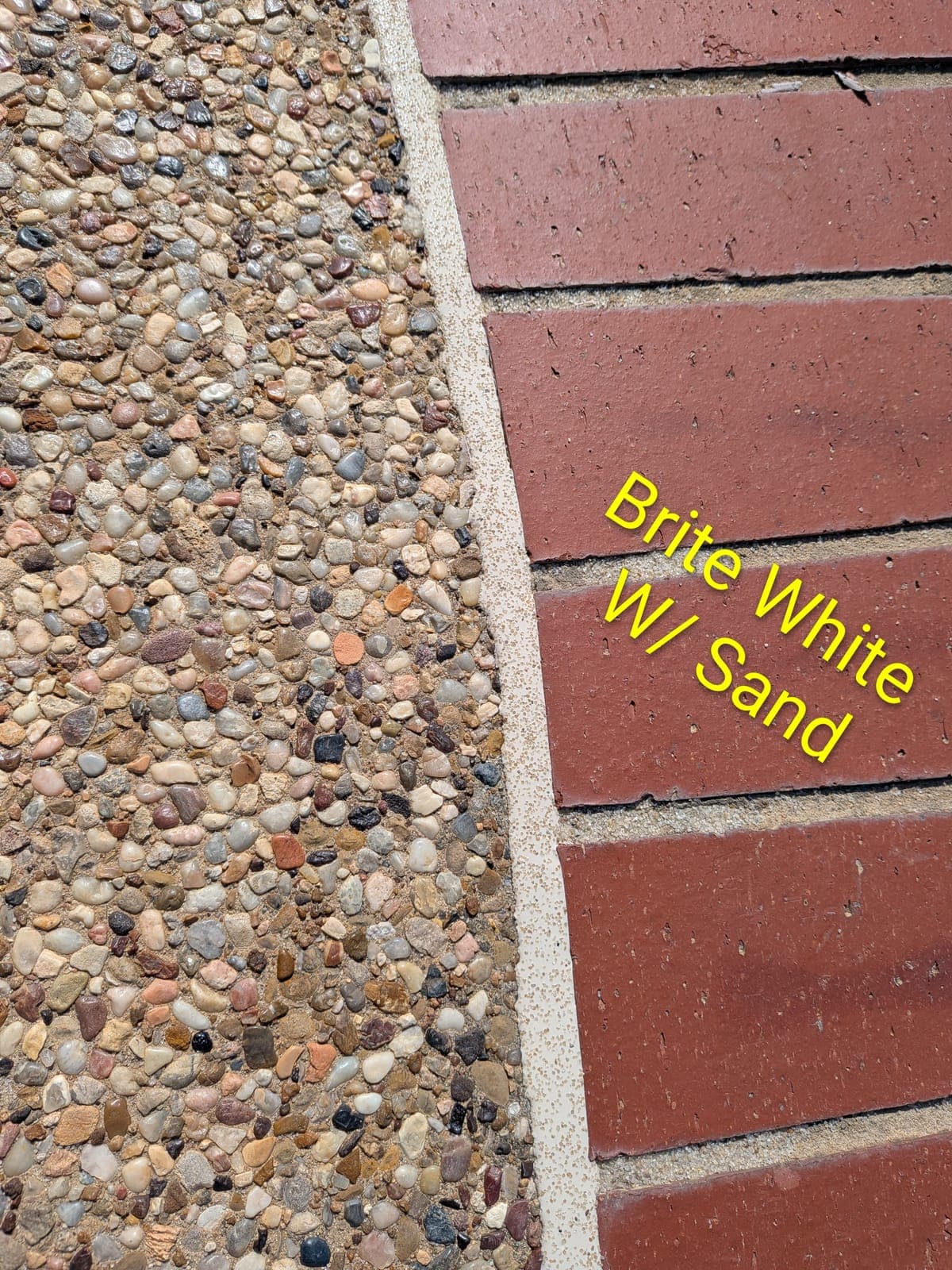Sika Brite White with Sand pool mastic sealant color example on exposed aggregate pool deck with brick border — textured sand finish