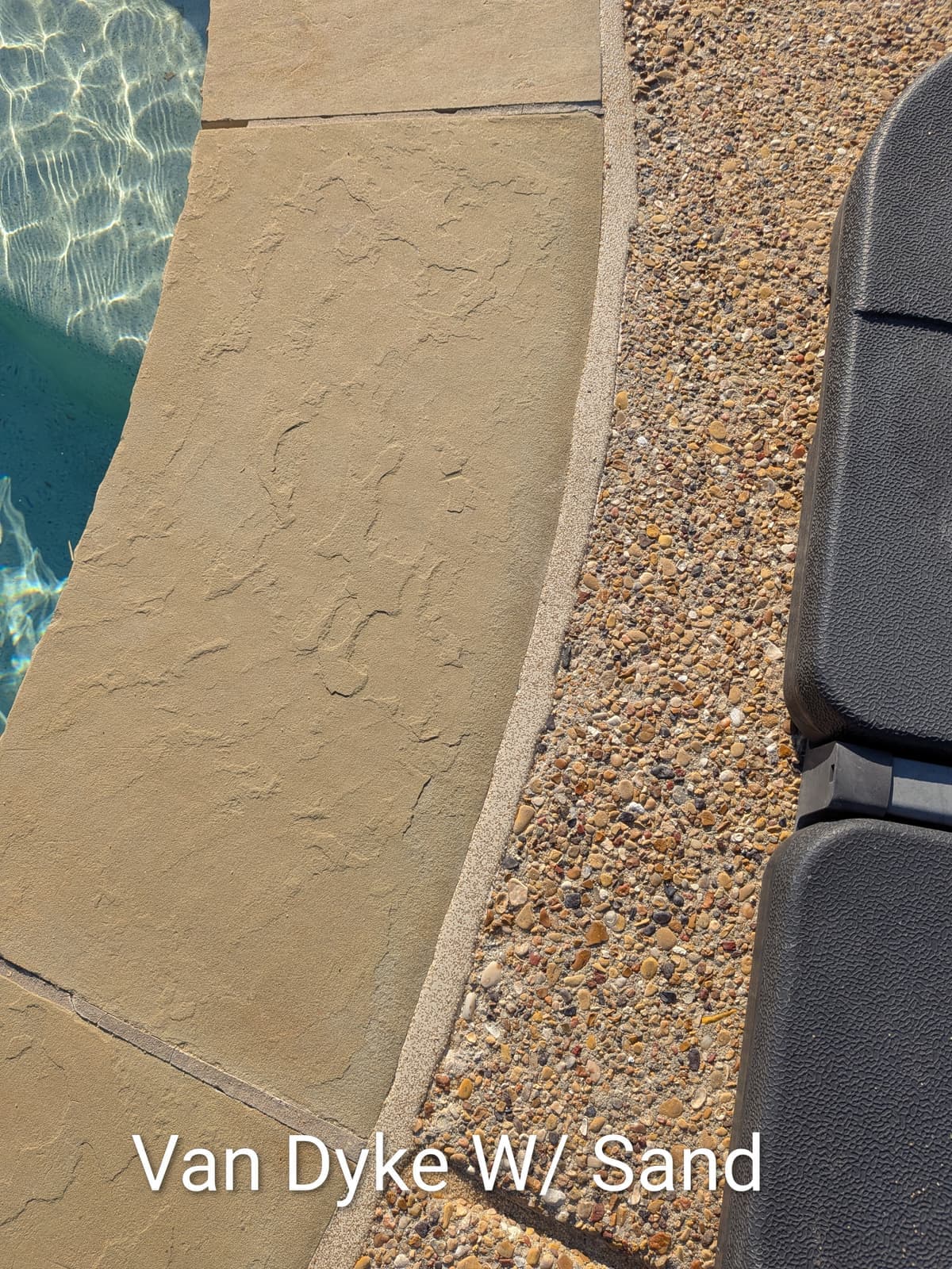 Sika Van Dyke with Sand pool mastic sealant color example on exposed aggregate pool deck — textured sand finish